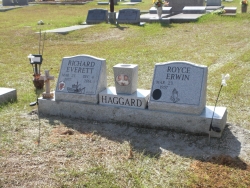 Double gray granite slant monument on a base with a vase and photo plaques in Lucedale, MS